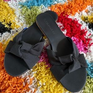 Rothy’s black sandals with bow strap